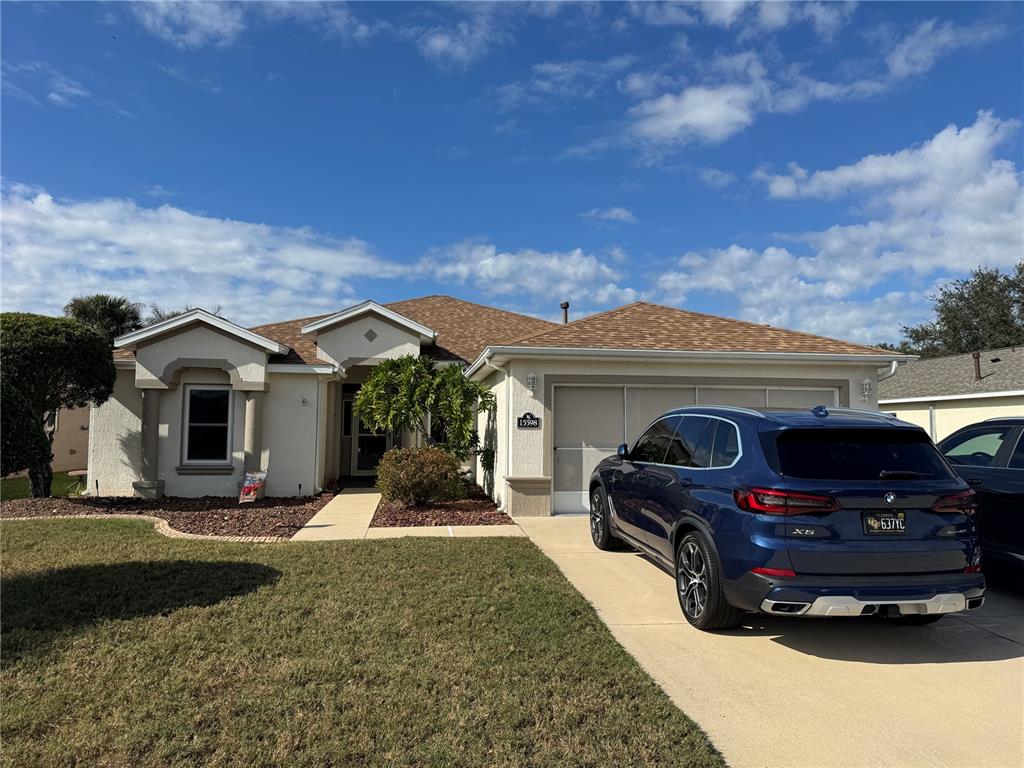 15598 Southwest 11th Terrace Road Ocala, FL 34473 - Photo 1 of 27 a front view of a house with garden