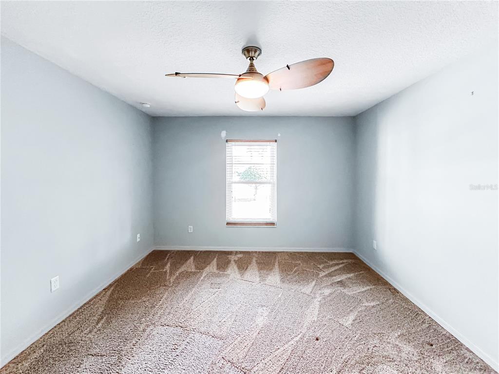 15598 Southwest 11th Terrace Road Ocala, FL 34473 - Photo 12 of 27 a view of empty room with wooden floor and fan