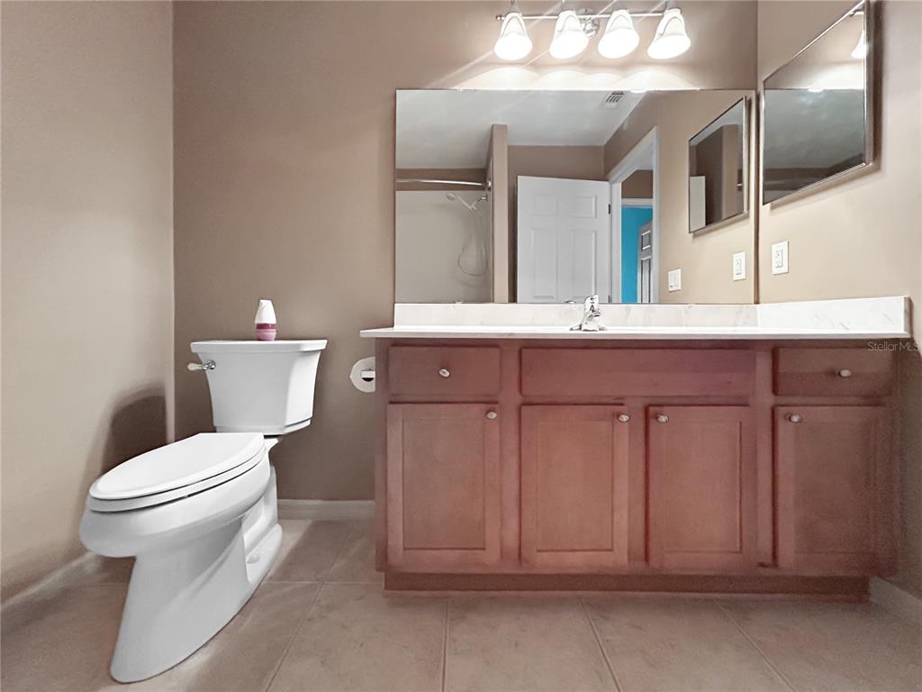 15598 Southwest 11th Terrace Road Ocala, FL 34473 - Photo 13 of 27 a bathroom with a toilet a sink and mirror