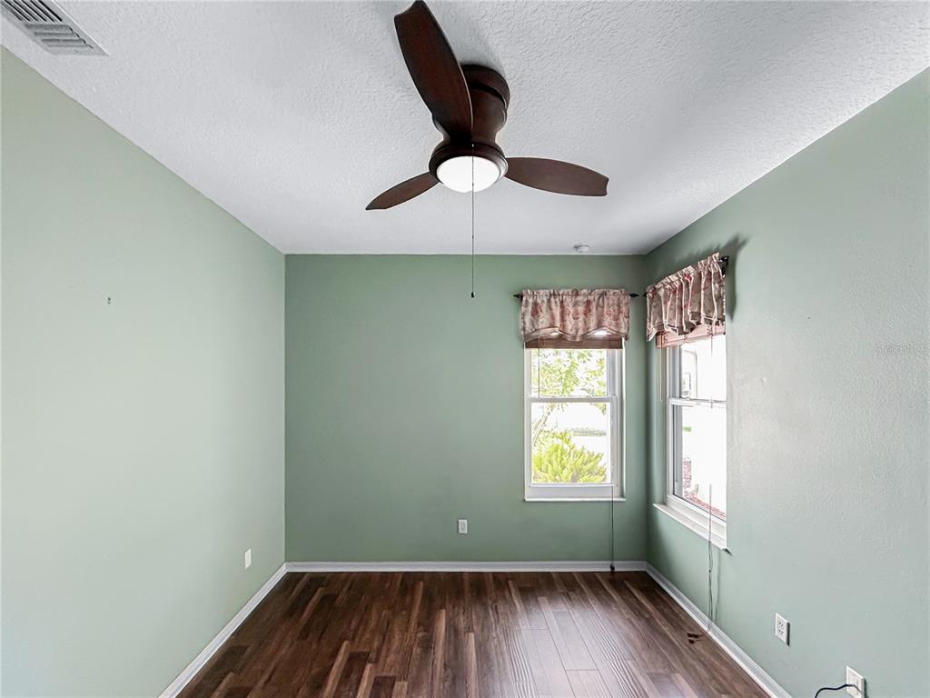 15598 Southwest 11th Terrace Road Ocala, FL 34473 - Photo 16 of 27 a view of an empty room with wooden floor and a window