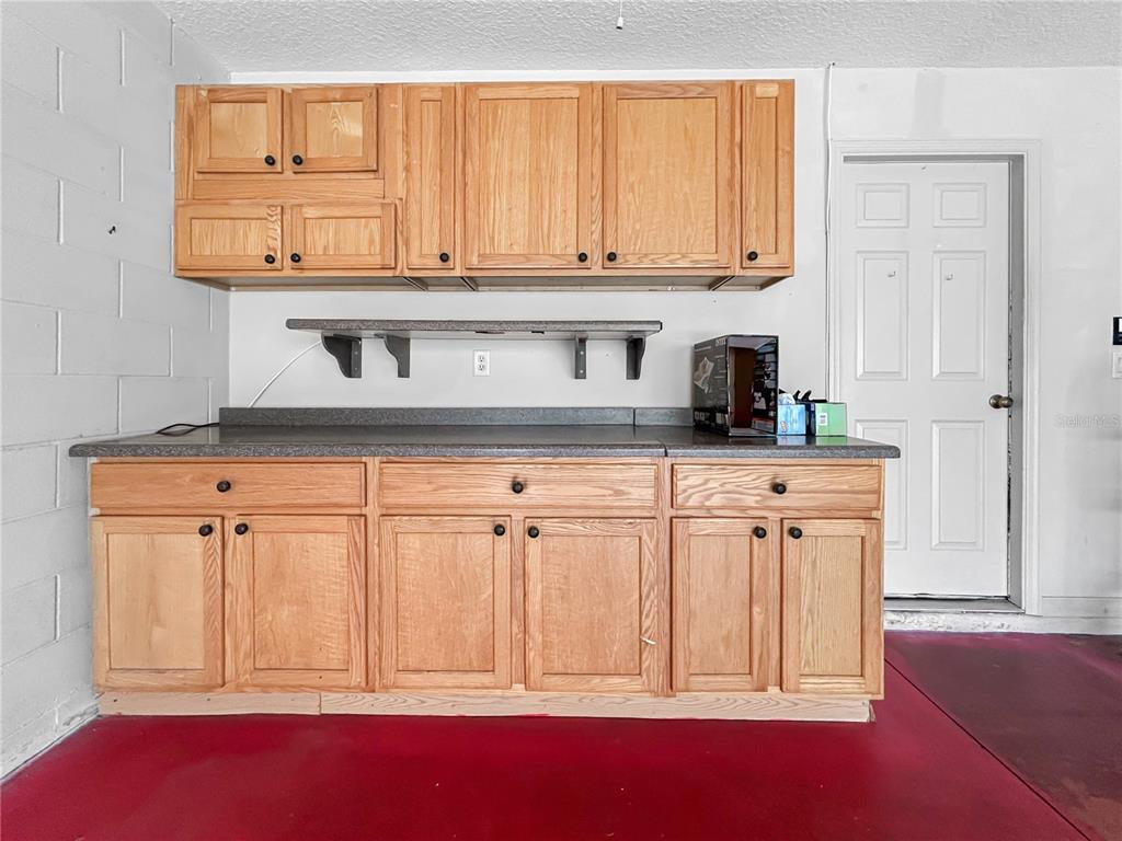 15598 Southwest 11th Terrace Road Ocala, FL 34473 - Photo 17 of 27 a kitchen with stainless steel appliances granite countertop a stove a sink and a white cabinets