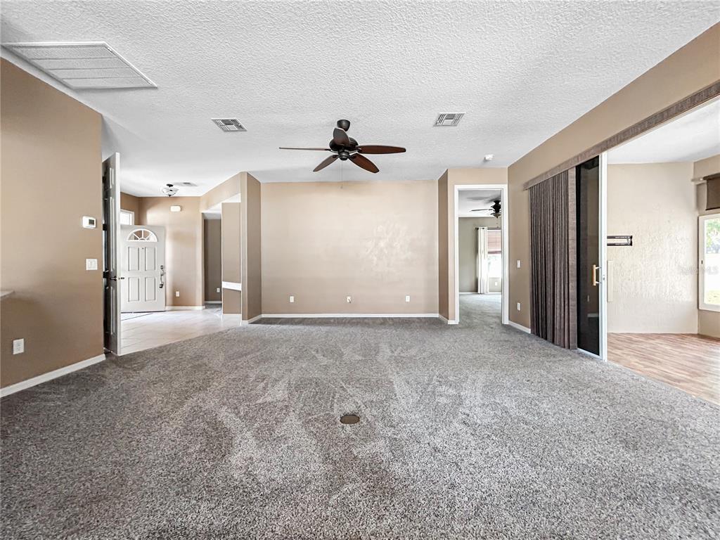 15598 Southwest 11th Terrace Road Ocala, FL 34473 - Photo 23 of 27 a view of a big room with closet and a ceiling fan