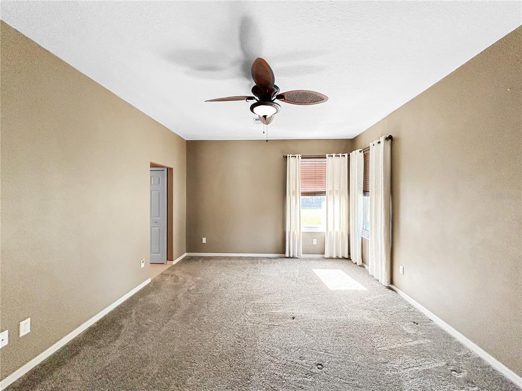 15598 Southwest 11th Terrace Road Ocala, FL 34473 - Photo 10 of 27 a view of a livingroom with a chandelier fan in a room