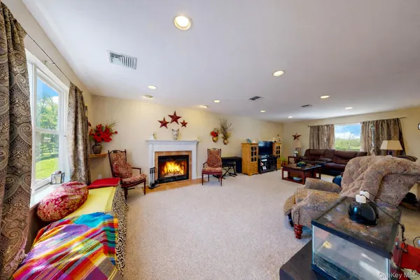 a living room with furniture a flat screen tv and a fireplace