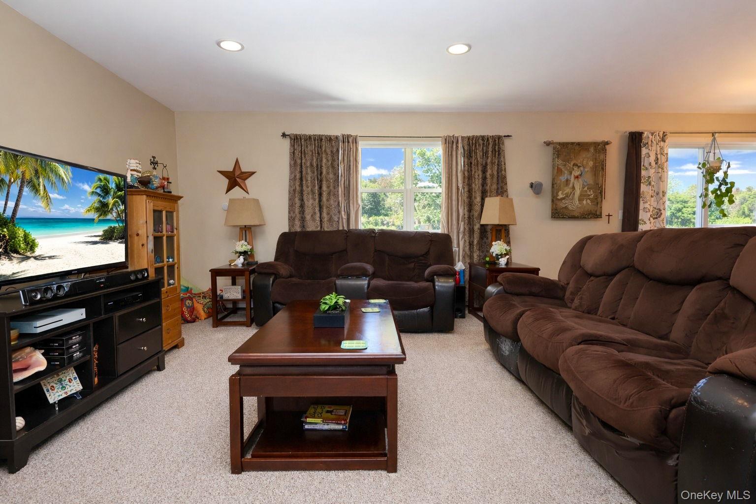 9 Mt Ridge Court Monroe, NY 10950 - Photo 15 of 49 a living room with furniture a flat screen tv and a fireplace