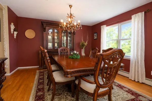 a view of a dining room with furniture and chandelier