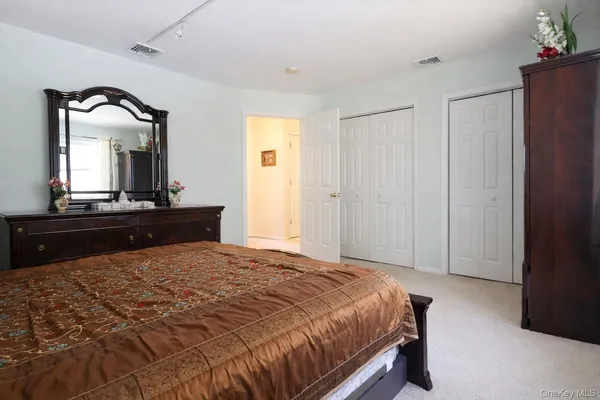 a bathroom with a sink a toilet a mirror and shower