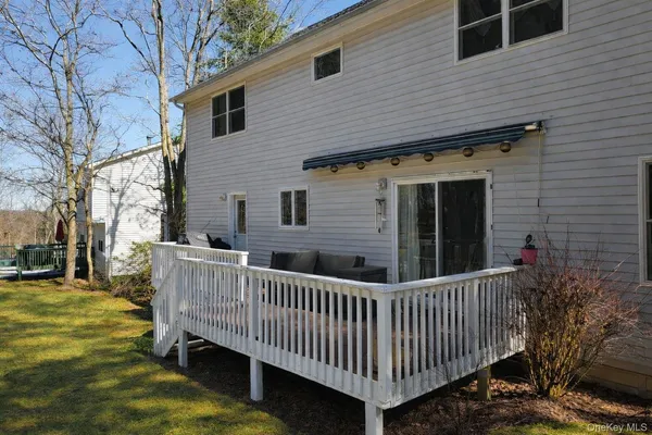 a view of a house with backyard swimming pool and sitting area