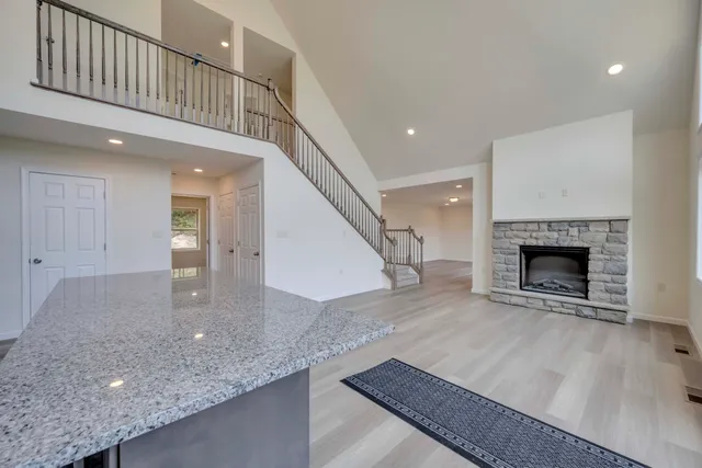 a view of a hallway with a fireplace and entryway