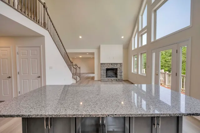 a large white kitchen with a large window