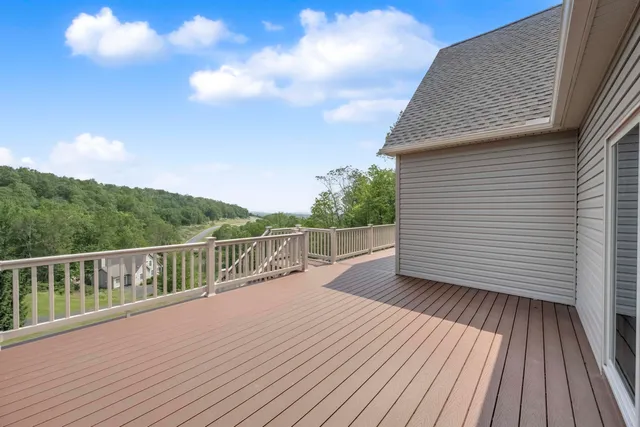 a view of a balcony with wooden floor