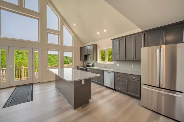 a kitchen with stainless steel appliances a sink stove and refrigerator