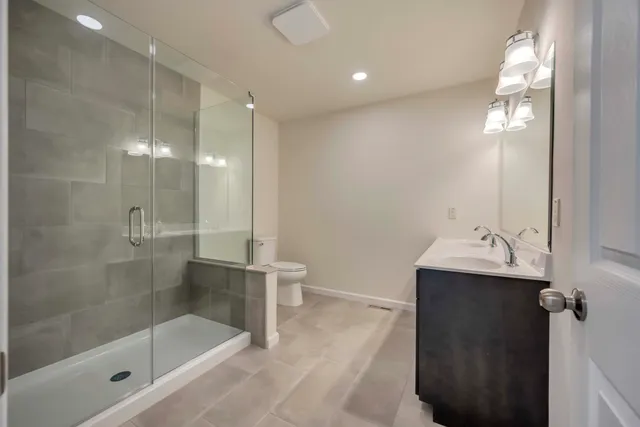 a bathroom with a shower and a toilet