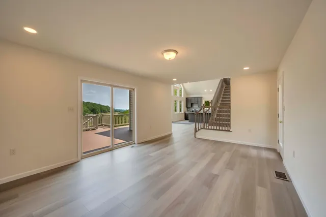 a view of an entryway with wooden floor