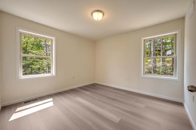 a view of an empty room and wooden floor