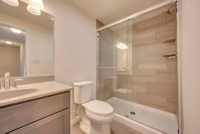 a bathroom with a sink toilet and shower
