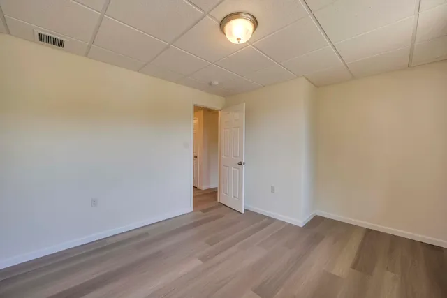 a view of a room with wooden floor