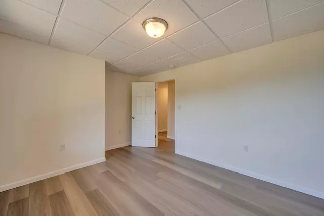 a view of an empty room with wooden floor
