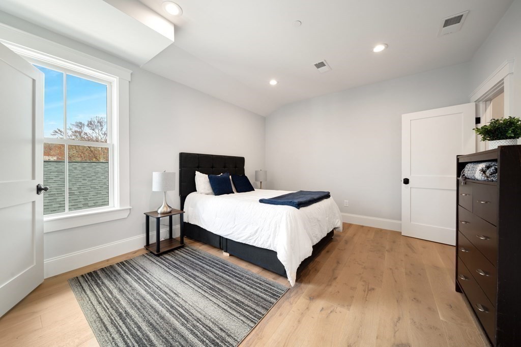 66 Fawndale Road, Unit 3 Boston, MA 02131 - Photo 12 of 15 a bedroom with a bed and a window