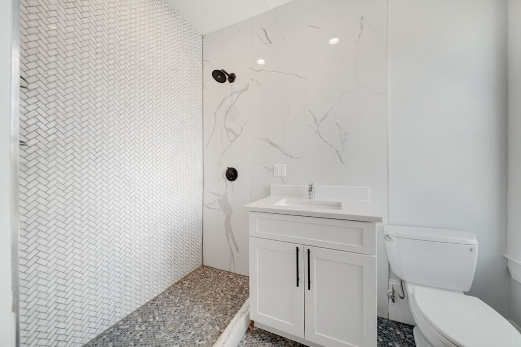 66 Fawndale Road, Unit 3 Boston, MA 02131 - Photo 14 of 15 a bathroom with a sink a toilet and shower
