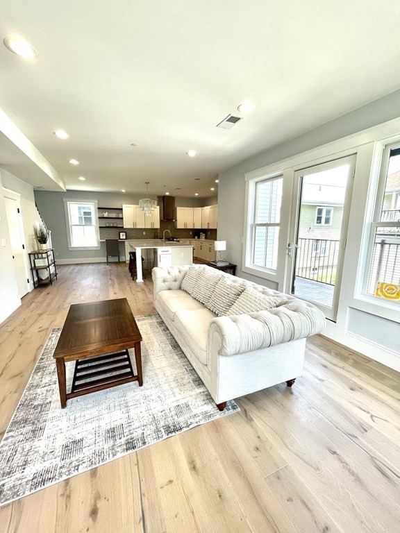 66 Fawndale Road, Unit 3 Boston, MA 02131 - Photo 3 of 15 a living room with furniture and a large window