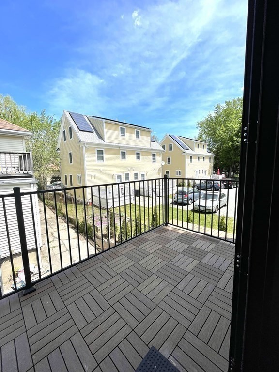 66 Fawndale Road, Unit 3 Boston, MA 02131 - Photo 4 of 15 a view of a balcony with wooden floor