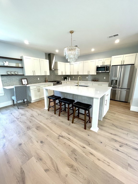 66 Fawndale Road, Unit 3 Boston, MA 02131 - Photo 5 of 15 a large kitchen with kitchen island a sink table and chairs