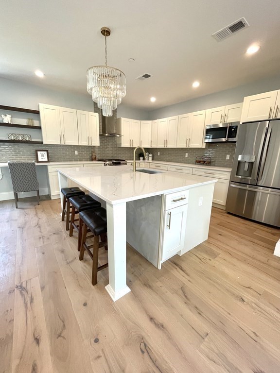 66 Fawndale Road, Unit 3 Boston, MA 02131 - Photo 6 of 15 a large kitchen with kitchen island a stove a sink a refrigerator and a dining table