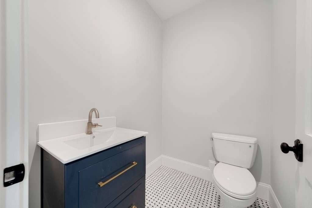 66 Fawndale Road, Unit 3 Boston, MA 02131 - Photo 7 of 15 a white toilet sitting next to a bathroom sink