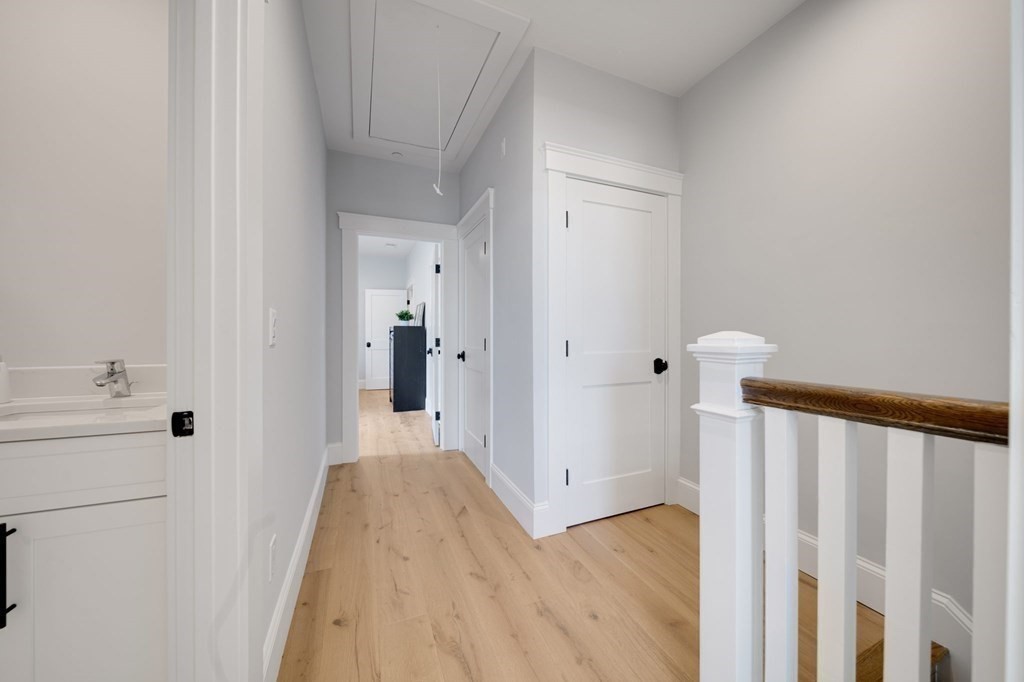 66 Fawndale Road, Unit 3 Boston, MA 02131 - Photo 10 of 15 a view of a hallway with wooden floor and a bathroom