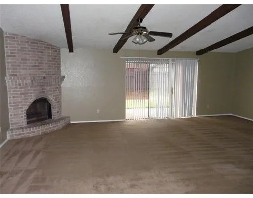 a view of an empty room with a fireplace