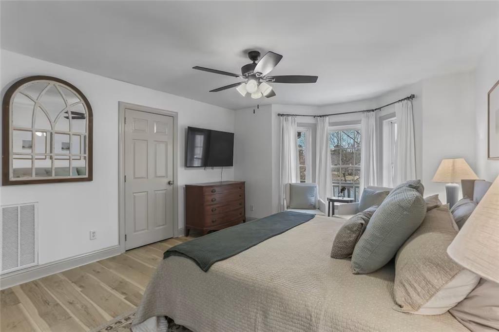 44 Sheffield Court Sparta, GA 31087 - Photo 12 of 24 a bedroom with a large bed and a flat screen tv