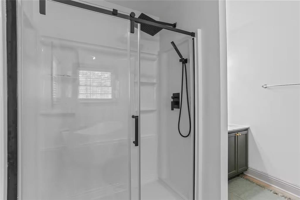 44 Sheffield Court Sparta, GA 31087 - Photo 14 of 24 a bathroom with a glass shower door