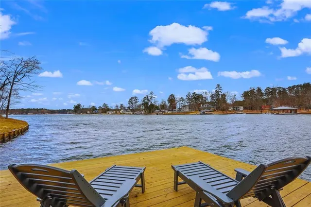 a view of swimming pool with lounge chair in front of house