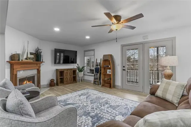 a living room with furniture a fireplace and a flat screen tv