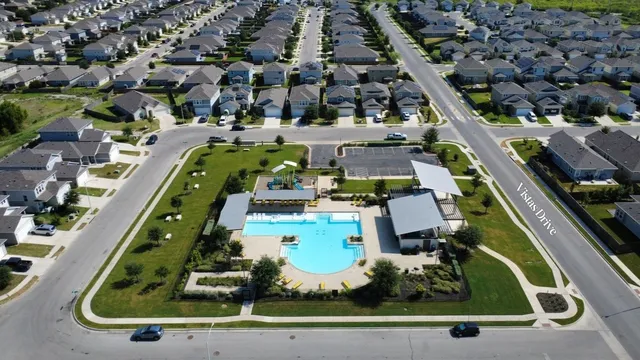 an aerial view of a residential houses with outdoor space