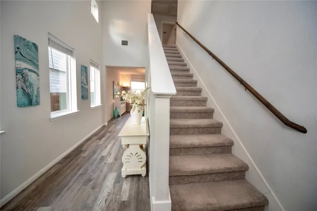 a view of entryway and hall with wooden floor