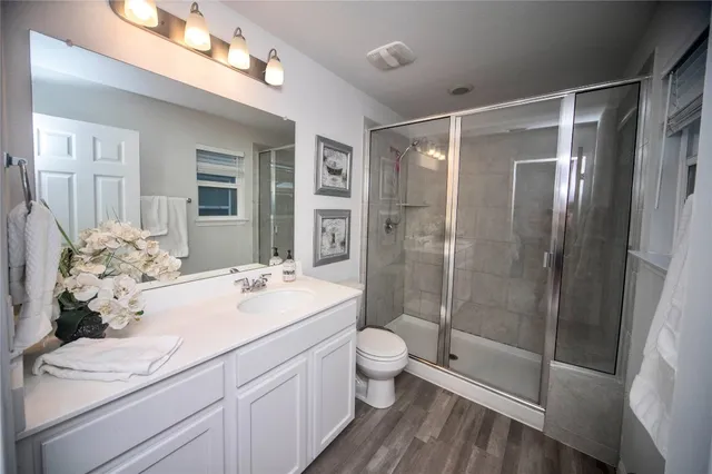 a bathroom with a sink a toilet and shower