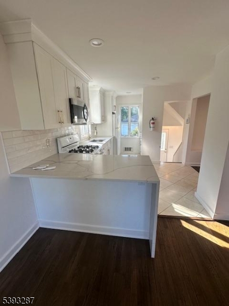 56 Buena Vista Road, Unit 1 Cedar Grove, NJ 07009 - Photo 1 of 16 a view of kitchen with sink microwave and stove