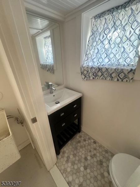 56 Buena Vista Road, Unit 1 Cedar Grove, NJ 07009 - Photo 14 of 16 a bath room with a sink and a toilet