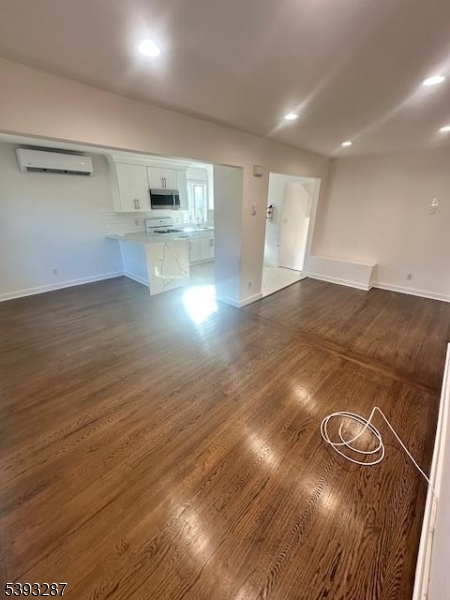 56 Buena Vista Road, Unit 1 Cedar Grove, NJ 07009 - Photo 5 of 16 a view of kitchen and empty room with wooden floor
