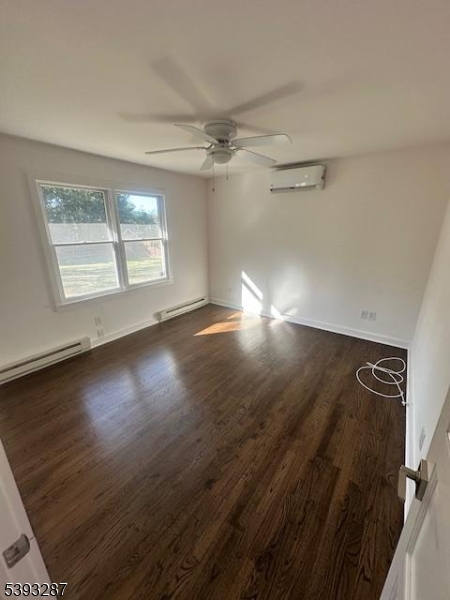 56 Buena Vista Road, Unit 1 Cedar Grove, NJ 07009 - Photo 10 of 16 an empty room with wooden floor fan and windows