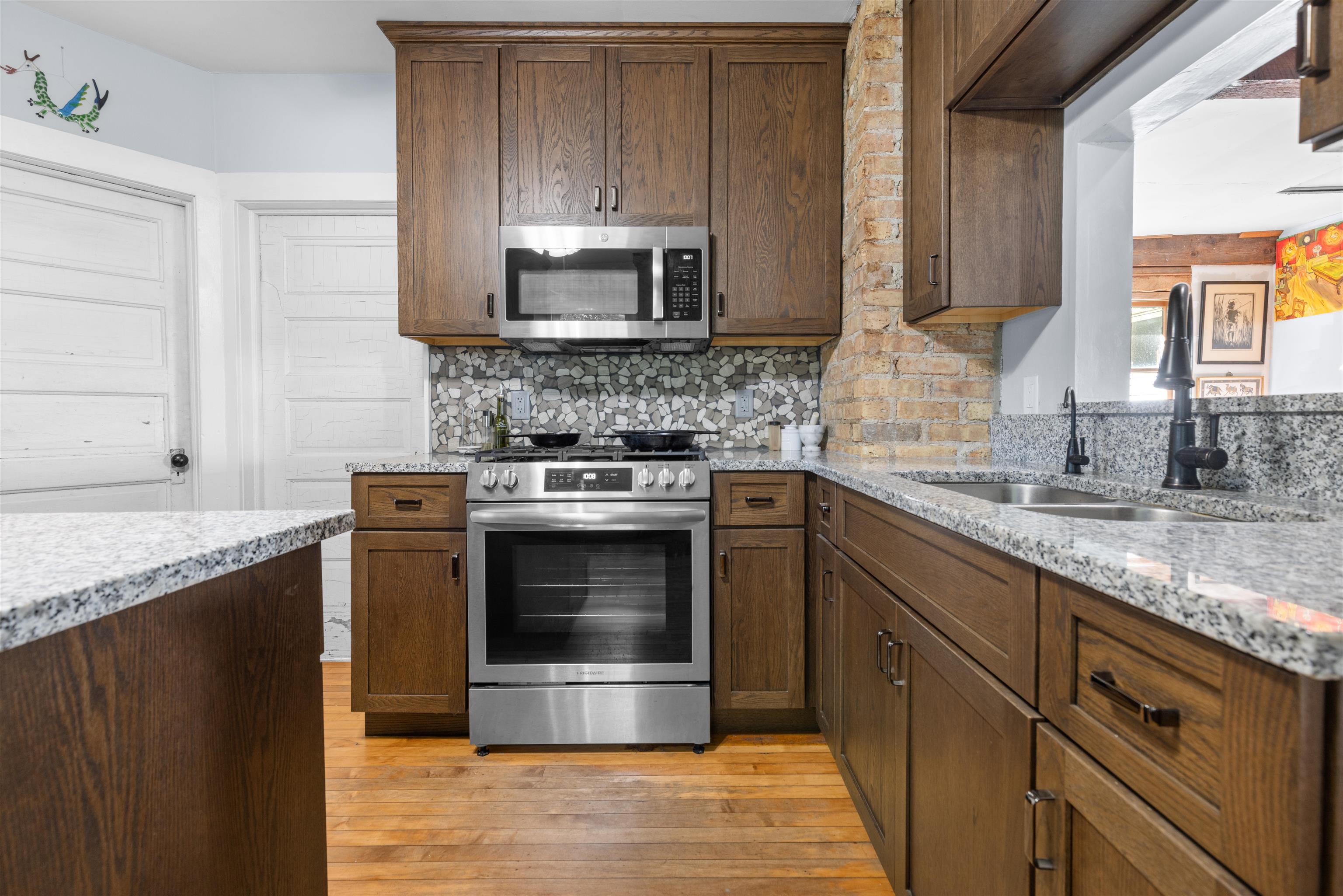 1610 South Turtle Town Hall Road Beloit, WI 53511 - Photo 16 of 50 a kitchen with stainless steel appliances granite countertop a stove a microwave and a sink