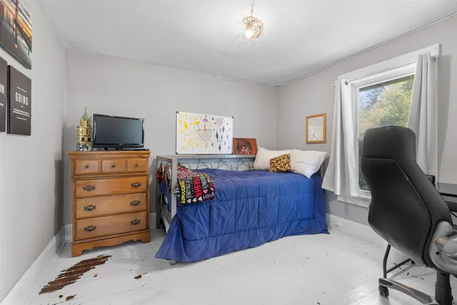 a bedroom with a bed and furniture