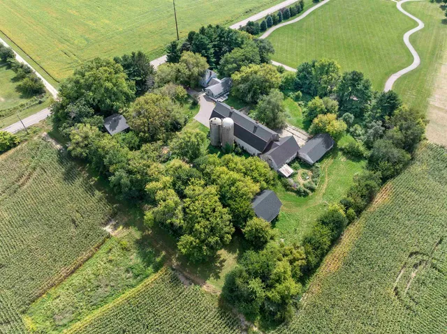 an aerial view of a house with a yard