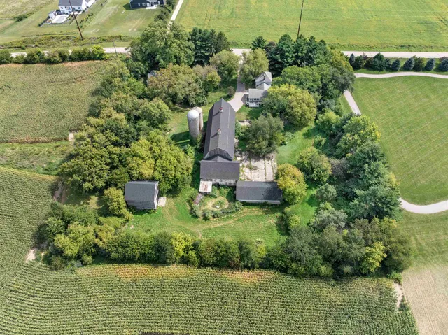 an aerial view of a house with a yard