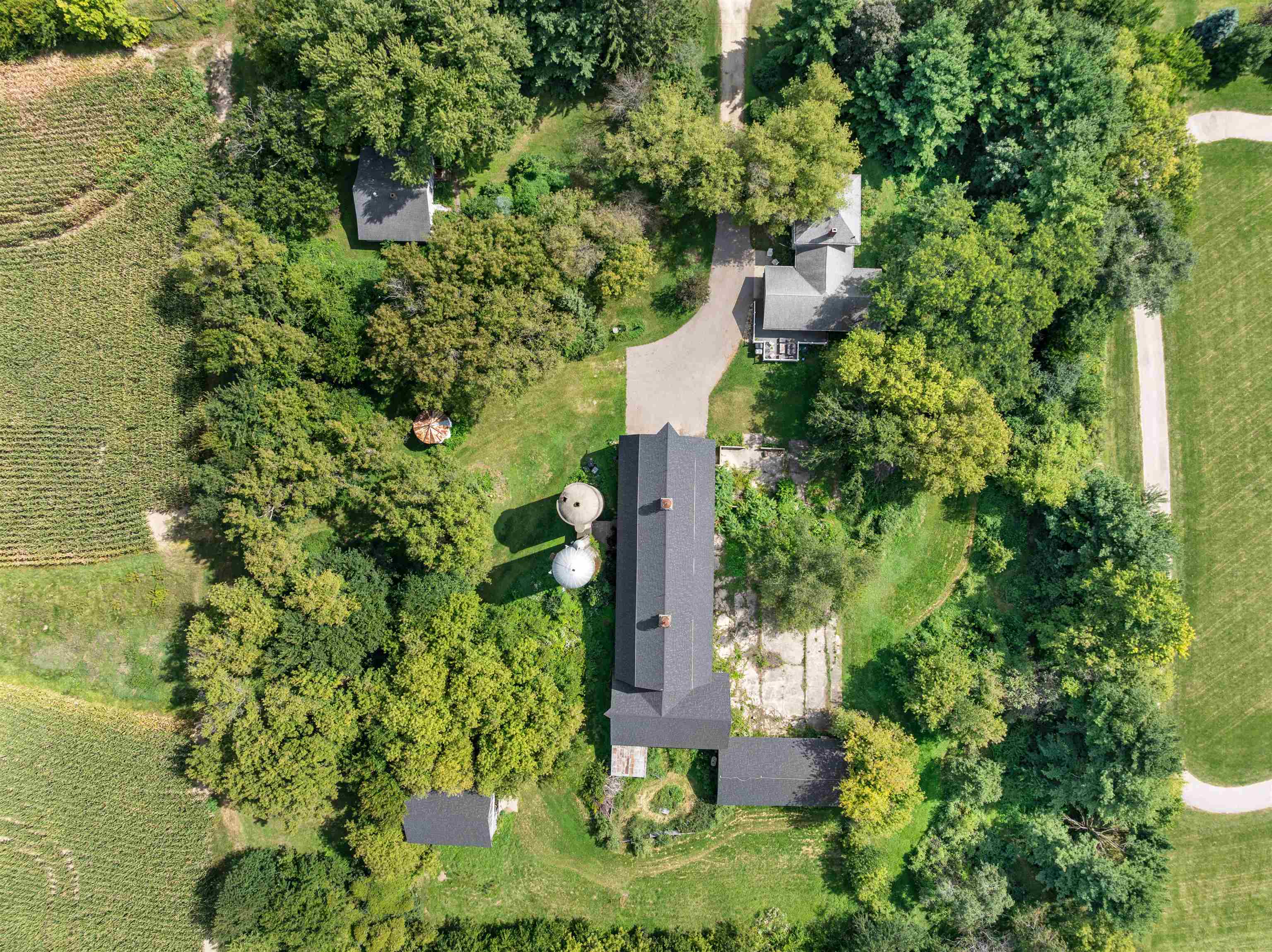 1610 South Turtle Town Hall Road Beloit, WI 53511 - Photo 48 of 50 an aerial view of a house with a yard lake and trees all around
