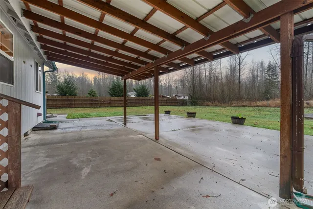 a view of a backyard with large trees