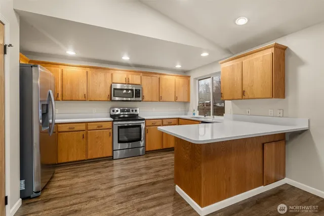 a kitchen with a sink stove and cabinets