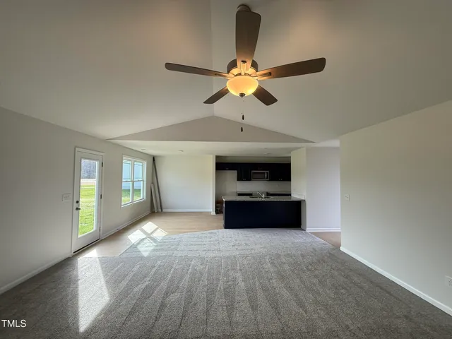 a living room with a couch and a ceiling fan
